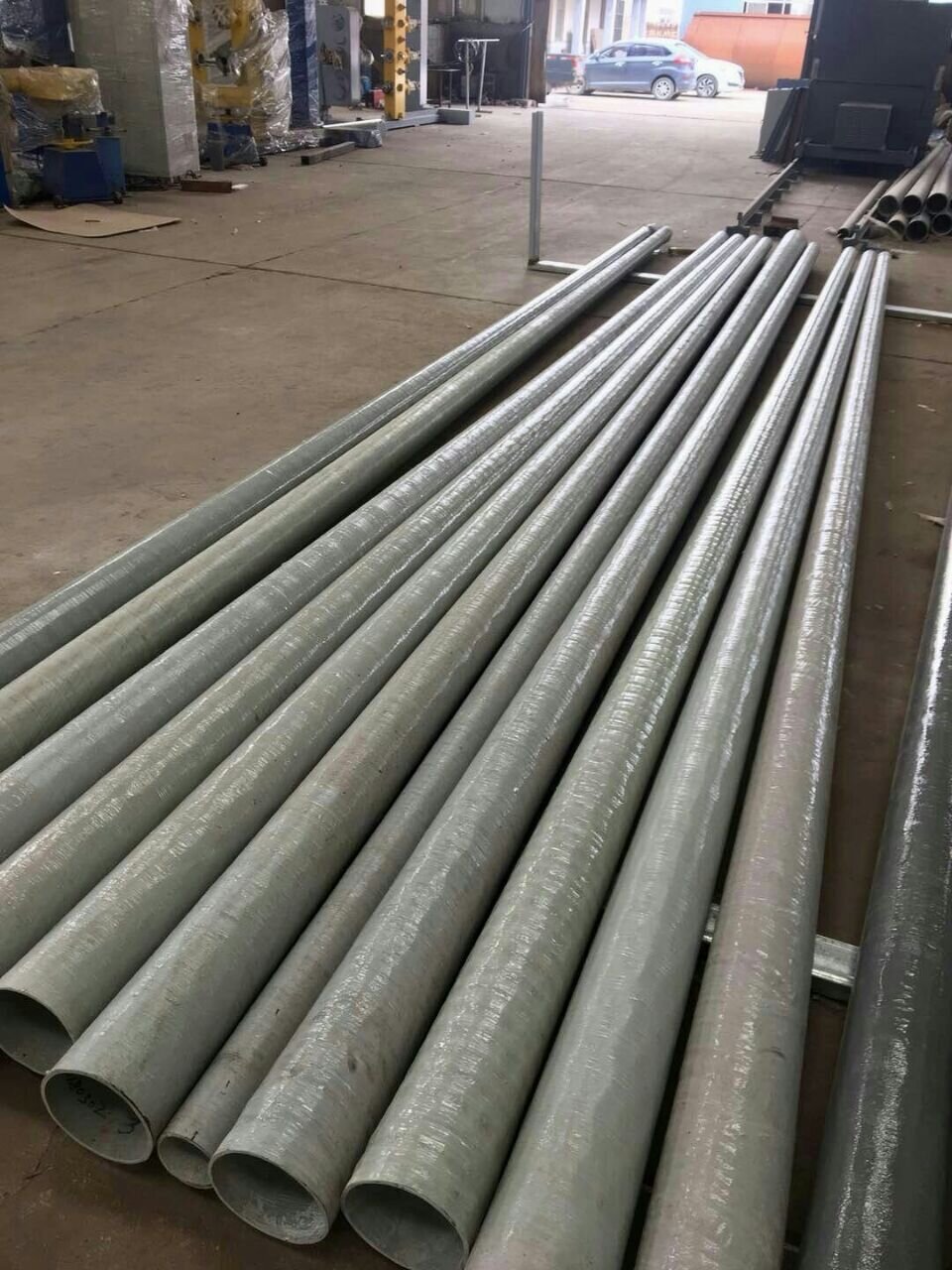 FRP utility poles bundled outdoors at the factory yard